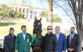 Knox Blackburn, Trainer Tim Smith, WGC CAVENDER, TWHBEA President Amanda Wright, TWHBEA CEO Mark Farrar, and TWHNC CEO Warren Wells pose together in front of the State Capitol buiding.