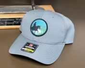 grey trails program hat on table